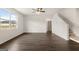 Open-concept living space with hardwood floors, a ceiling fan, and staircase access at 560 Whitman Ln # 2016, Stockbridge, GA 30281