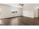 A spacious living room with a ceiling fan, window, and a door to the outdoor space at 560 Whitman Ln # 2016, Stockbridge, GA 30281
