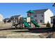 Green and tan playground with slides and climbing structures located in the community at 560 Whitman Ln # 2016, Stockbridge, GA 30281