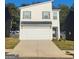 Charming two-story home featuring a painted brick facade, attached garage, and a paved driveway at 4831 Station Lane # 29, Union City, GA 30349