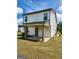 A view of the back of the house with covered porch and green lawn at 4838 Station Lane # 15, Union City, GA 30349