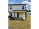 Backyard featuring a covered patio, spacious lawn, and a view of neighboring houses at 4838 Station Lane # 15, Union City, GA 30349