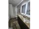 Well-lit bathroom with double sinks, granite countertops, and a modern shower/tub combo at 4838 Station Lane # 15, Union City, GA 30349
