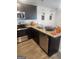 Modern kitchen with granite countertops, stainless steel appliances, and dark wood cabinetry at 4838 Station Lane # 15, Union City, GA 30349