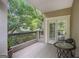 A cozy balcony with wood flooring and views of lush, mature trees for relaxed outdoor seating at 3192 Paces Mill Se Rd, Atlanta, GA 30339
