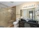 Bathroom featuring a glass shower with a shower seat, a modern vessel sink, and a large, illuminated mirror at 3192 Paces Mill Se Rd, Atlanta, GA 30339