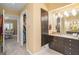 Well-lit bathroom with dual vanities and granite countertop, connecting to the Primary bedroom and walk-in closet at 3192 Paces Mill Se Rd, Atlanta, GA 30339