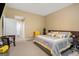 View of the bedroom with beige walls showcasing large bed with gray and yellow accent pillows, and a gray comforter at 3192 Paces Mill Se Rd, Atlanta, GA 30339