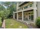Multi-level home exterior with covered patios, manicured lawn, and garden area, perfect for outdoor entertaining at 3192 Paces Mill Se Rd, Atlanta, GA 30339