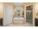 Luxurious bathroom with a large tub, shower, and mosaic tile accents at 3192 Paces Mill Se Rd, Atlanta, GA 30339