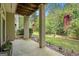 A covered patio with a view to the lawn featuring lush landscaping and well-maintained garden beds at 3192 Paces Mill Se Rd, Atlanta, GA 30339
