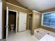 Bright bathroom featuring a soaking tub, white cabinets, and a separate toilet room at 3838 Kirkwood Nw Run, Kennesaw, GA 30144