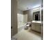Well-lit bathroom featuring a shower-tub combo, toilet, and a vanity with a sink and mirror at 3838 Kirkwood Nw Run, Kennesaw, GA 30144