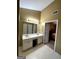 Bathroom features a double sink vanity with white cabinets and a large mirror with vanity lighting at 3838 Kirkwood Nw Run, Kennesaw, GA 30144