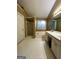 Bathroom featuring a tiled floor, soaking tub, glass door shower, and a double sink vanity at 3838 Kirkwood Nw Run, Kennesaw, GA 30144