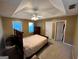 Spacious bedroom featuring a tray ceiling, carpet flooring, a window, and traditional furnishings at 3838 Kirkwood Nw Run, Kennesaw, GA 30144