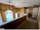 Upstairs hallway with view of arched window, pendant lights and bedrooms doors at 3838 Kirkwood Nw Run, Kennesaw, GA 30144