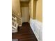 Hallway with dark wood flooring, staircase, and white door, blending functionality with style at 3838 Kirkwood Nw Run, Kennesaw, GA 30144