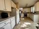 Well-lit kitchen features ample cabinet space and modern appliances with backyard views at 3838 Kirkwood Nw Run, Kennesaw, GA 30144