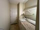 This laundry room features a washer and dryer with overhead shelving and a tiled floor at 3838 Kirkwood Nw Run, Kennesaw, GA 30144