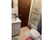 Compact bathroom featuring a sink, toilet, and shower-tub combo at 603 New Hope Rd, Fayetteville, GA 30214