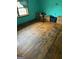 Bedroom with wooden floors, teal walls, and a window at 603 New Hope Rd, Fayetteville, GA 30214