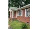 Brick home with white trim and a green roof at 603 New Hope Rd, Fayetteville, GA 30214
