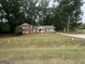 Charming brick home featuring a green roof, white shutters, and a well-maintained front yard at 603 New Hope Rd, Fayetteville, GA 30214