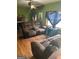 Inviting living room with hardwood floors and comfortable seating, complemented by a brick fireplace at 603 New Hope Rd, Fayetteville, GA 30214