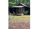 Rustic wooden outbuilding with a covered porch and tin roof at 603 New Hope Rd, Fayetteville, GA 30214