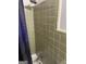 A basic shower stall with green tile and a shower curtain at 603 New Hope Rd, Fayetteville, GA 30214