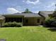 Home exterior with a screened-in porch visible from a green lawn under a sunny sky at 6190 Douglas Manor Ct, Douglasville, GA 30134