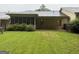 Exterior shot of the backyard and screened in back porch of a home at 6190 Douglas Manor Ct, Douglasville, GA 30134