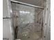 Modern bathroom shower showcasing marble walls, grab bars, and built-in seating at 6190 Douglas Manor Ct, Douglasville, GA 30134