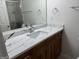 Bathroom vanity featuring a white countertop and wood cabinetry, plus framed mirror at 6190 Douglas Manor Ct, Douglasville, GA 30134