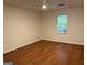 Bright bedroom with hardwood floors, ceiling fan, and natural light from a window at 6190 Douglas Manor Ct, Douglasville, GA 30134