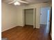 Bedroom featuring wood flooring and a closet with bi-fold doors at 6190 Douglas Manor Ct, Douglasville, GA 30134