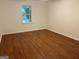 Spacious bedroom with hardwood floors and a window overlooking the backyard at 6190 Douglas Manor Ct, Douglasville, GA 30134