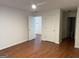 Open bedroom with hardwood floors and access to bathroom and hallway at 6190 Douglas Manor Ct, Douglasville, GA 30134