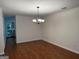 Bright dining room featuring hardwood floors, crown molding, and modern lighting fixture at 6190 Douglas Manor Ct, Douglasville, GA 30134