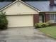 Charming single-story home featuring a brick facade, attached garage, and well-maintained front yard at 6190 Douglas Manor Ct, Douglasville, GA 30134