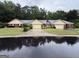 Street view of single-story homes with brick and tan facades, garages, and green lawns at 6190 Douglas Manor Ct, Douglasville, GA 30134