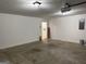 Large, clean garage space with an open ceiling and concrete floor at 6190 Douglas Manor Ct, Douglasville, GA 30134