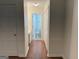 Hallway leads to bathroom, features wood floors and white doors at 6190 Douglas Manor Ct, Douglasville, GA 30134