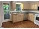 Well-equipped kitchen with stainless steel appliances, wooden cabinets, and natural light at 6190 Douglas Manor Ct, Douglasville, GA 30134