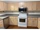 Spacious kitchen featuring wooden cabinets, stainless steel appliances, and ample counter space at 6190 Douglas Manor Ct, Douglasville, GA 30134