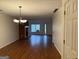 Inviting living room with hardwood floors, a brick fireplace, and natural light from the window at 6190 Douglas Manor Ct, Douglasville, GA 30134
