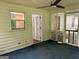 A comfortable enclosed screened porch with ceiling fan and access to an interior door at 6190 Douglas Manor Ct, Douglasville, GA 30134