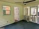 A comfortable enclosed screened porch with ceiling fan and access to an interior door at 6190 Douglas Manor Ct, Douglasville, GA 30134