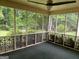 Spacious screened porch with decorative railing, perfect for outdoor entertaining at 6190 Douglas Manor Ct, Douglasville, GA 30134